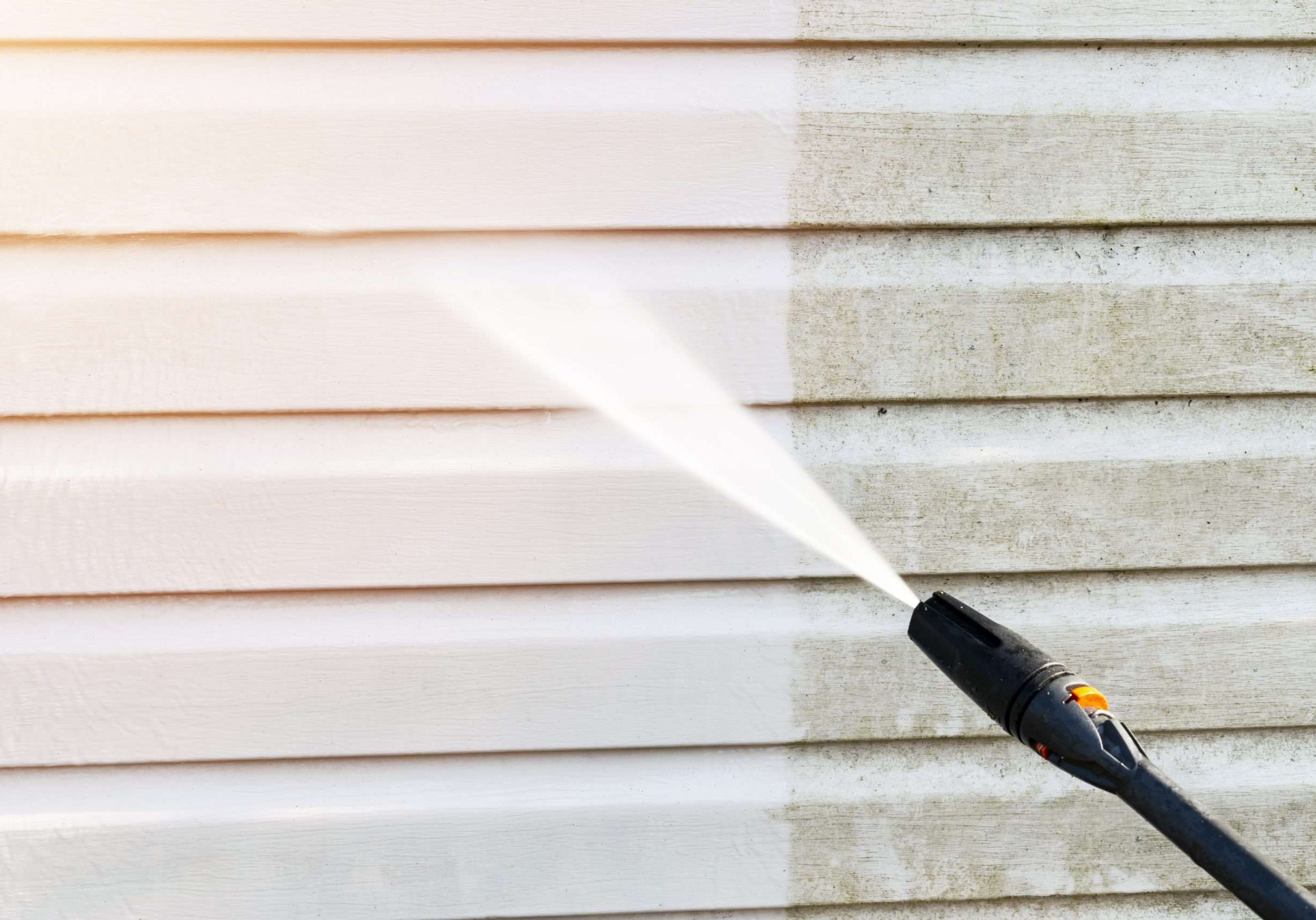 Cleaning service washing building facade with pressure water. Cleaning dirty waill with high pressure water jet. Power washing the wall. Ceaning the facade of the house. Before and after washing
